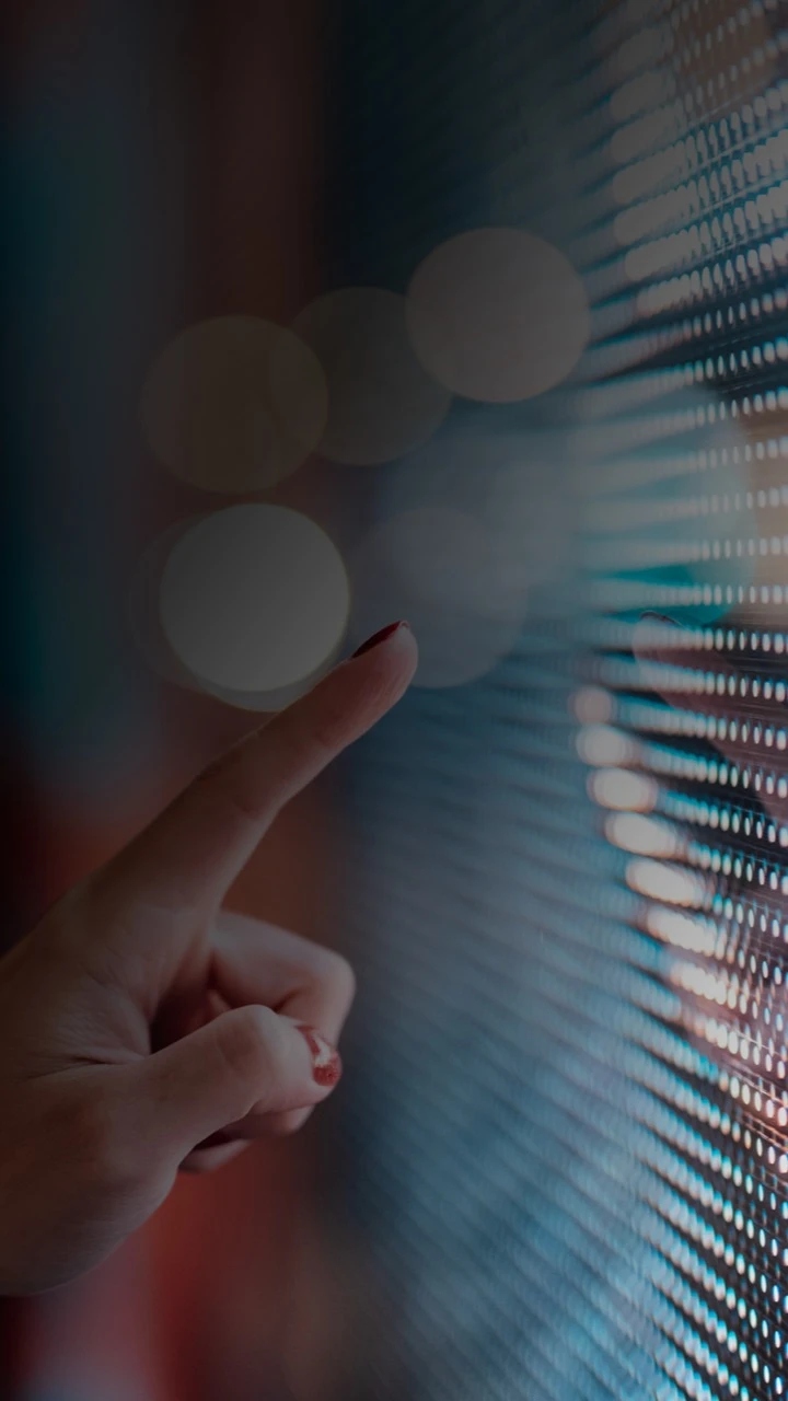 A hand touching a screen
