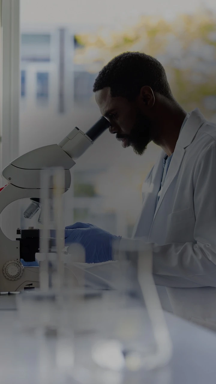 A person looking into a microscope