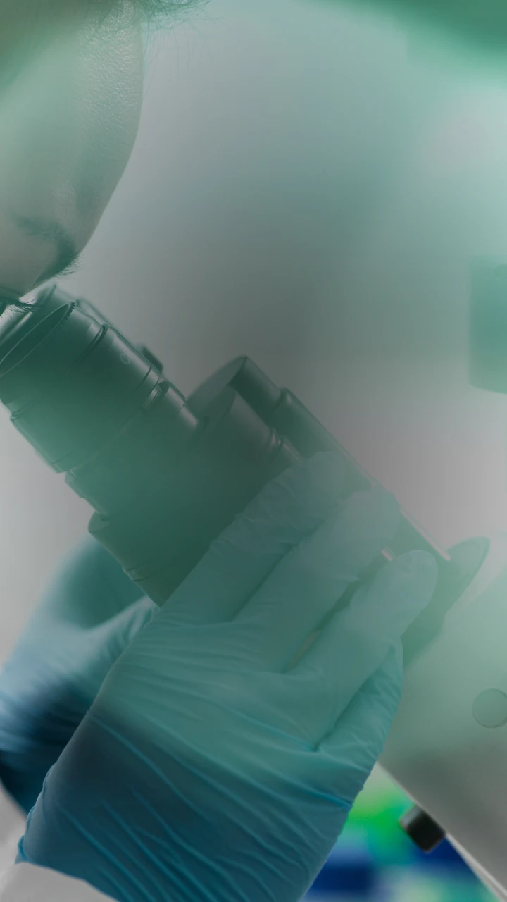doctor looking in microscope